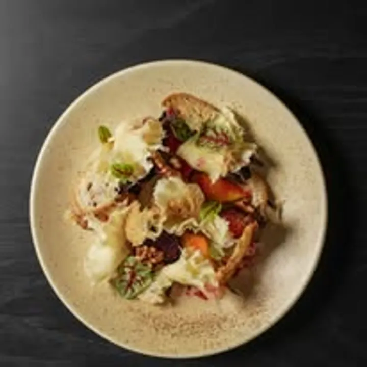 Bruschetta with burrata and roasted tomatoes on ceramic plate