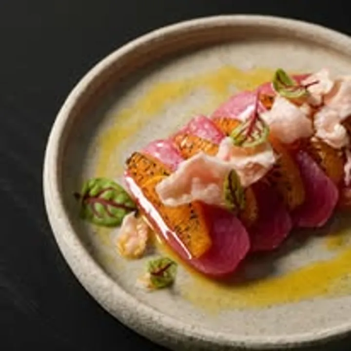 Elegantly plated vegetable and cured fish dish at Una Una