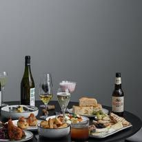 Una Una dinner spread on dark round table — the full Box Hill bistro experience